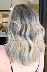 the back of a woman's wavy blonde bob