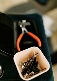 a pair of pliers on a table next to a bowl