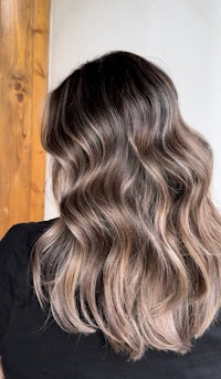 the back of a woman's hair with a wavy ombre